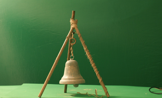 The bell hanging from a make-shift support.